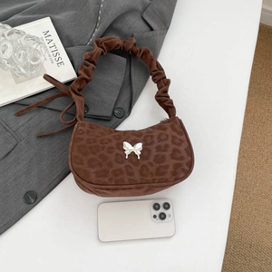 Leopard print crescent shoulder bag with metallic butterfly and pleated handle