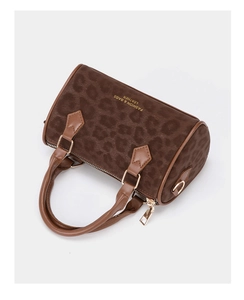 Detail view of leopard print Boston bag with gold hardware and side text branding