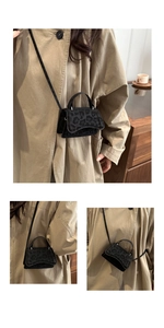 Detail view of stylish black leopard print flap handbag with top handle and crossbody strap