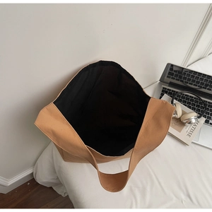 Vue macro du compartiment intérieur spacieux avec doublure noire et bandoulière en toile