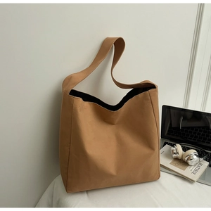 Macro shot of dark khaki canvas tote bag with thick material and wide shoulder strap