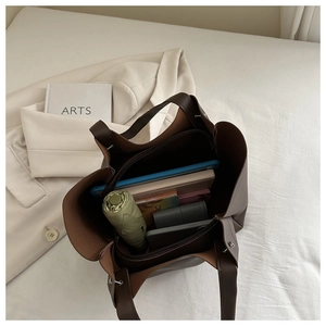 Spacious tote bag interior with compartments holding a tablet, umbrella, and daily items