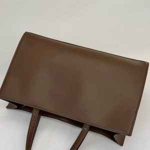 Classic brown PU leather tote bag with fine stitching and spacious interior for daily commute