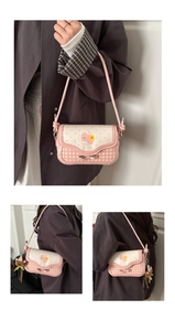Pink plaid crossbody bag detail with bow decoration and cute plush bear accessory