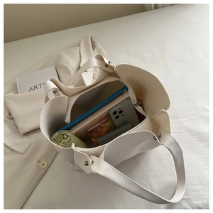 Interior detail of large cream tote bag showing spacious storage for daily essentials
