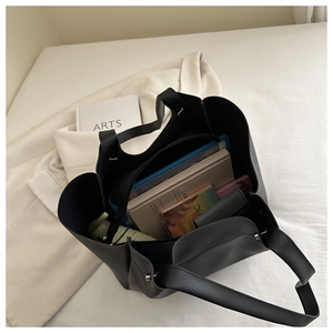 Top view of large black tote bag showing organized interior with laptop and books