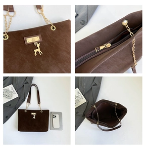 Detail view of brown tote bag with gold chain strap, deer pendant, and spacious interior