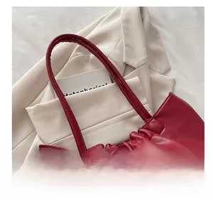 Detail view of burgundy leather tote bag with drawstring closure and interior storage space