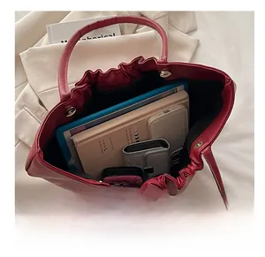 Interior view of burgundy leather tote bag showing large capacity for books and tablet