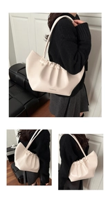 Macro detail of creamy white pleated tote bag with black FASHION BAGS text print