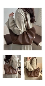 Detail of dark brown pleated leather tote with golden Fashion Bags logo lettering