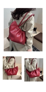 Macro detail of red ruched cloud bag showing premium leather texture and soft pleats