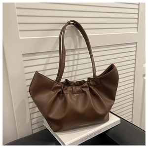 Detail of soft pleated cloud tote in dark brown with gold fashion bags lettering