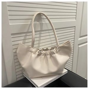 Detailed close-up of creamy white ruched tote bag with soft PU leather texture and pleats