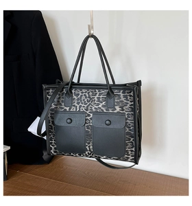 Detail of leopard print tote bag with symmetrical front flap pockets and metallic hardware