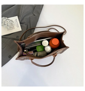 Top view of large leopard print tote bag interior showing spacious storage for laptop