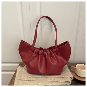 Close-up of pleated dark red cloud tote bag showing soft PU leather and gathered handle