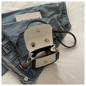 Interior view of small beige PU crossbody bag showing storage for lipstick and cushion