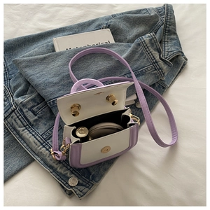 Detail view of mini lavender and white PU leather handbag showing interior storage capacity
