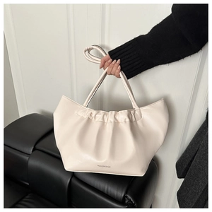 Close-up of cream pleated tote bag featuring soft PU leather and Fashion Bags logo