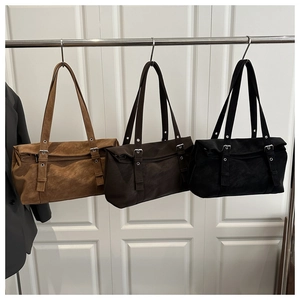 Three retro suede shoulder bags in brown, coffee, and black with double belt buckle detail