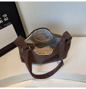 Vista interna della spaziosa borsa tote marrone scuro con scomparti multipli e fodera