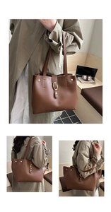 Detailed view of brown leather tote bag with gold oval buckle and fine double handles