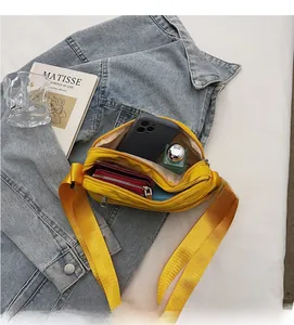 Internal view of yellow nylon crossbody bag showing spacious compartments and storage capacity