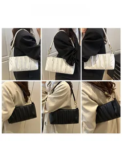 Detail view of ruched cloud bags in black and white with woven shoulder straps