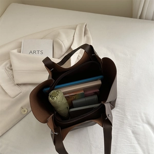 Deep brown minimalist tote bag showing spacious interior with iPad and daily essentials