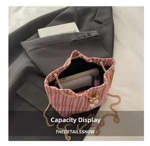Internal view of tweed bucket bag showing capacity for phone, wallet and lipstick