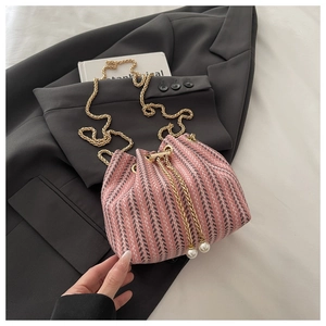 Detail of pink and grey woven bucket bag with gold chain strap and pearl drawstring