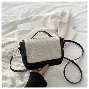 Detail of a vintage plush saddle bag with faux fur flap and gold hardware accents
