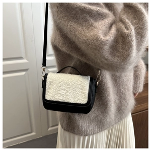 Detail of vintage plush saddle bag showing faux fur texture and black leather contrast