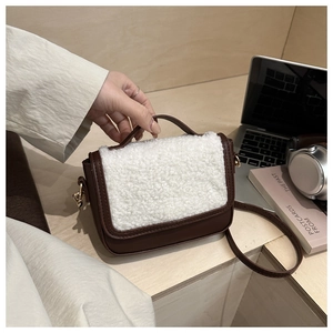 Detail of vintage saddle bag with brown leather and white plush shearling texture