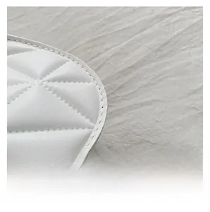 Close-up of diamond quilted stitching and premium faux leather texture on the white handbag