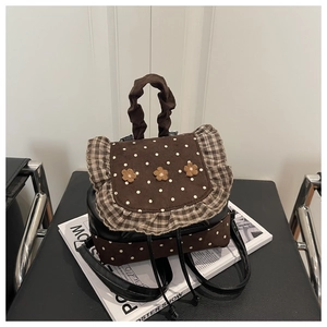Detail of floral polka dot backpack with ruffled edges and pleated fabric handle