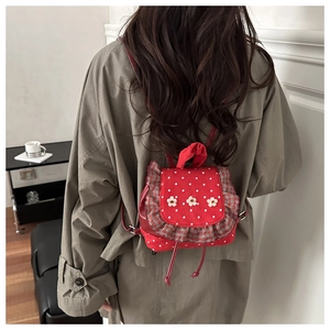Mini red polka dot backpack with ruffles and floral accents for stylish women