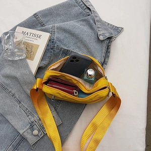 Yellow nylon crossbody bag with dual-zipper compartments and spacious storage capacity