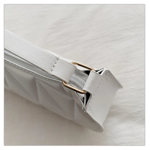 Detail of white quilted handbag showing geometric stitching and golden metal hardware