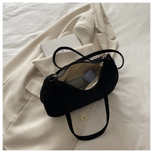 Internal view of black matte suede shoulder bag showing storage capacity and sleek lining
