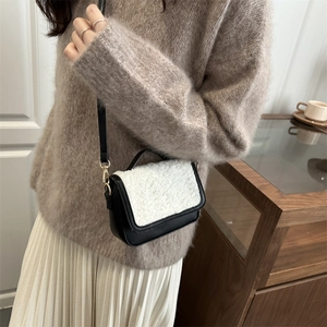 French vintage plush saddle bag with black and white contrast design on a female model