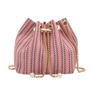 Pink and white woven bucket bag with chevron pattern and gold pearl drawstring chain