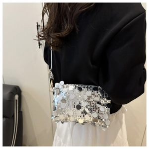 Silver sequin shoulder bag with large reflective discs and thin white strap on model