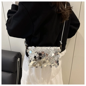 Detail view of large silver sequins and metal chain strap on minimalist crossbody bag