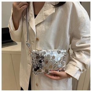 Detailed close-up of large silver sequins and metallic chain strap on a crossbody bag