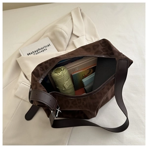 Detail showing the large capacity of the leopard print tote bag with various essentials