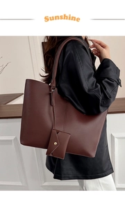 Detail of a large brown PU leather tote bag with matching envelope pouch charm