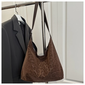 Detail of leopard print hobo bag showing faux suede texture and adjustable strap