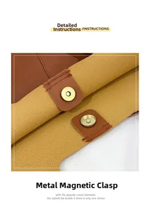 Detail of dual-tone leather tote bag featuring gold magnetic snap closure and precise stitching